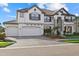 Attractive two-story home showcasing a brick driveway, tropical landscaping and an attached two-car garage at 33105 Kateland Dr, Wesley Chapel, FL 33545