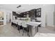 Spacious kitchen with a large island, modern appliances, and dark cabinetry, perfect for cooking and entertaining at 33105 Kateland Dr, Wesley Chapel, FL 33545
