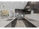 Well-lit kitchen featuring stainless steel appliances, an expansive island, and dark cabinets offering style and functionality at 33105 Kateland Dr, Wesley Chapel, FL 33545