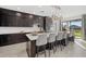 Contemporary kitchen with dark cabinetry, a large center island, and stainless steel appliances at 33105 Kateland Dr, Wesley Chapel, FL 33545