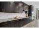 Modern kitchen featuring granite countertops, subway tile backsplash, and sleek, dark cabinets providing ample storage at 33105 Kateland Dr, Wesley Chapel, FL 33545