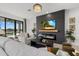 Elegant living room featuring a modern fireplace, recessed lighting, and views of the lush backyard at 33105 Kateland Dr, Wesley Chapel, FL 33545