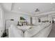 Spacious living room featuring a comfortable sectional sofa, modern lighting, and serene decor at 33105 Kateland Dr, Wesley Chapel, FL 33545