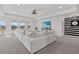 Bright living room featuring a large white sectional sofa and scenic lake views at 33105 Kateland Dr, Wesley Chapel, FL 33545