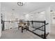 Upstairs loft area featuring a foosball table and rod iron bannister at 33105 Kateland Dr, Wesley Chapel, FL 33545