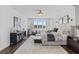 Beautiful bedroom with water view, modern decor, and wood floors at 33105 Kateland Dr, Wesley Chapel, FL 33545
