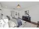 Spacious main bedroom with plush bedding, a view, and dark wood floors at 33105 Kateland Dr, Wesley Chapel, FL 33545