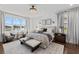 Stunning main bedroom featuring a view, elegant chandelier, and a cozy sitting area at 33105 Kateland Dr, Wesley Chapel, FL 33545