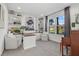 Bright home office featuring built-in bookshelves and a comfortable seating area by the window at 33105 Kateland Dr, Wesley Chapel, FL 33545
