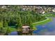 Scenic community view of a waterfall feature with a walking path, lush landscaping, and tranquil lake at 33105 Kateland Dr, Wesley Chapel, FL 33545