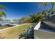 Picturesque backyard with dock, lush greenery, waterfall feature, and waterfront access at 3418 Overlook Ne Dr, St Petersburg, FL 33703