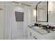Updated bathroom with modern fixtures, stylish mirror, and shower with decorative tile at 3418 Overlook Ne Dr, St Petersburg, FL 33703