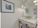 Chic bathroom vanity with white countertop, marble sink, and artistic light fixtures at 3418 Overlook Ne Dr, St Petersburg, FL 33703