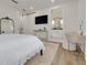 This bedroom has a TV, an ensuite bathroom, access to an office space, a chair, and neutral paint at 3418 Overlook Ne Dr, St Petersburg, FL 33703