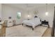 Well-lit bedroom boasting a desk, ceiling fan, and hardwood floors at 3418 Overlook Ne Dr, St Petersburg, FL 33703