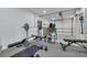 A home gym with free weights, a weight bench, and workout machines, accessible from the garage at 3418 Overlook Ne Dr, St Petersburg, FL 33703
