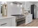 Modern kitchen with a stainless steel stove, white backsplash, and pendant lighting at 3418 Overlook Ne Dr, St Petersburg, FL 33703