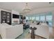 Cozy living room with large windows, modern fireplace, and comfortable seating overlooking the water at 3418 Overlook Ne Dr, St Petersburg, FL 33703