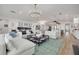 Spacious living room with an open layout, connecting to a modern kitchen, dining area, and wet bar at 3418 Overlook Ne Dr, St Petersburg, FL 33703