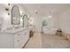 Main bathroom offers dual vanities, soaking tub, modern fixtures, and decorative mirrors at 3418 Overlook Ne Dr, St Petersburg, FL 33703
