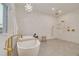 Main bathroom features soaking tub with modern fixtures, bright tile, and decorative lighting at 3418 Overlook Ne Dr, St Petersburg, FL 33703