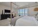 Luxurious primary bedroom featuring water views, stylish furnishings, and natural light at 3418 Overlook Ne Dr, St Petersburg, FL 33703