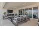 Covered outdoor area with a fire pit, TV, and waterfront views, creating an ideal entertainment space at 3418 Overlook Ne Dr, St Petersburg, FL 33703