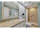 Bathroom features granite countertop, framed mirror, and accessible shower for convenience at 36750 Us 19 N # 06211, Palm Harbor, FL 34684