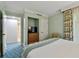 Bedroom with TV, closet, en suite bathroom and patterned curtains adding elegance to the space at 36750 Us 19 N # 06211, Palm Harbor, FL 34684