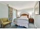 Relaxing bedroom featuring a queen bed, floral curtains, and a charming side chair at 36750 Us 19 N # 06211, Palm Harbor, FL 34684