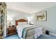 Comfortable bedroom with a queen bed, patterned curtains, and elegant wall art at 36750 Us 19 N # 06211, Palm Harbor, FL 34684