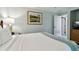 Serene bedroom with a queen bed, soft lighting, and peaceful golf course artwork at 36750 Us 19 N # 06211, Palm Harbor, FL 34684