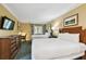 Bright bedroom featuring two queen beds, a work desk, and a flat screen TV at 36750 Us 19 N # 06211, Palm Harbor, FL 34684