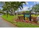 Well maintained community entrance with lush lawn, landscaping, and clear signage at 36750 Us 19 N # 06211, Palm Harbor, FL 34684