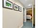 Hallway with decorative golf-themed artwork leading to a bedroom, creating an inviting atmosphere at 36750 Us 19 N # 06211, Palm Harbor, FL 34684