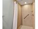 Accessible shower with grab bars, tiled walls, and a shower curtain for safety at 36750 Us 19 N # 06211, Palm Harbor, FL 34684