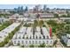 An aerial view showcasing the modern townhome development with a stunning city skyline backdrop at 401 N Oregon Ave # 1, Tampa, FL 33606