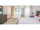 Cozy main bedroom with modern furniture, wood floors, and a connecting bathroom at 401 N Oregon Ave # 1, Tampa, FL 33606