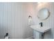 Stylish powder room with patterned wallpaper, modern fixtures, and a clean, minimalist design at 401 N Oregon Ave # 1, Tampa, FL 33606