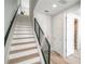 Modern staircase with sleek railings and light wood flooring, leading to the upper level at 401 N Oregon Ave # 1, Tampa, FL 33606