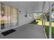 View of a covered back porch with sliding glass doors leading to the interior of the home at 4102 E Seward St, Tampa, FL 33617