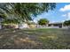 Expansive backyard with a storage shed, lush lawn, and a wooden fence, providing ample outdoor space and privacy at 4105 W Iowa Ave, Tampa, FL 33616