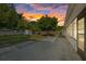 Large backyard featuring concrete patio, mature trees and storage shed during sunset at 4105 W Iowa Ave, Tampa, FL 33616