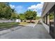 Large backyard featuring concrete patio, mature trees, and privacy fence at 4105 W Iowa Ave, Tampa, FL 33616