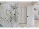 Modern bathroom features a glass enclosed shower with marble tile surround and flooring, and modern fixtures at 4105 W Iowa Ave, Tampa, FL 33616