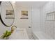 Bright bathroom with a stylish vanity with marble countertop, and a shower/tub combo with white subway tile at 4105 W Iowa Ave, Tampa, FL 33616