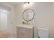 Bright bathroom featuring a modern vanity with decorative round mirror and stylish patterned floor tile at 4105 W Iowa Ave, Tampa, FL 33616