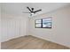 This empty bedroom features hardwood floors, a ceiling fan, closet, and a large window at 4105 W Iowa Ave, Tampa, FL 33616