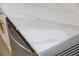 Close-up of marble-look countertop with stainless steel dishwasher featuring gold hardware at 4105 W Iowa Ave, Tampa, FL 33616