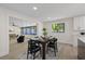 Bright dining room features wood floors, black window frames and black furniture at 4105 W Iowa Ave, Tampa, FL 33616